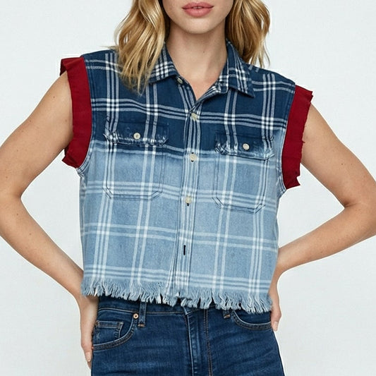 Woman wearing a blue plaid shirt and dark jeans on a white background