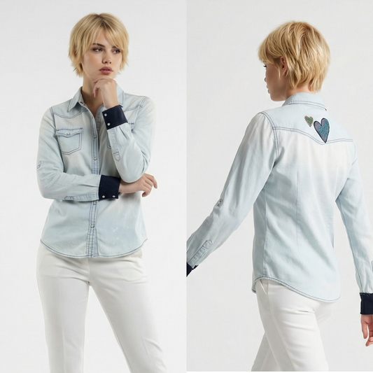 Woman wearing a light blue denim shirt with heart designs on a white background